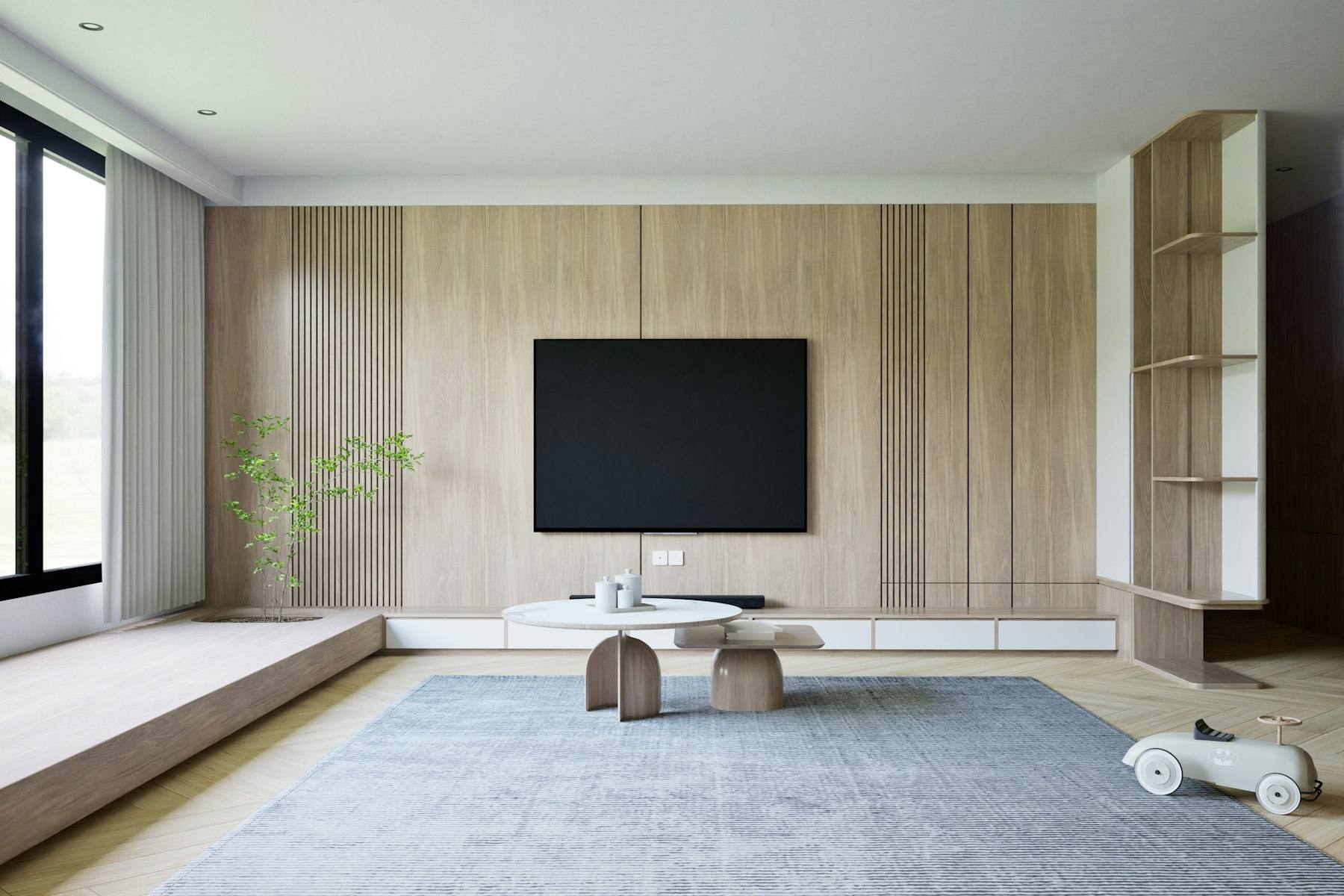 A bright living room with light wood panelling and a low TV unit