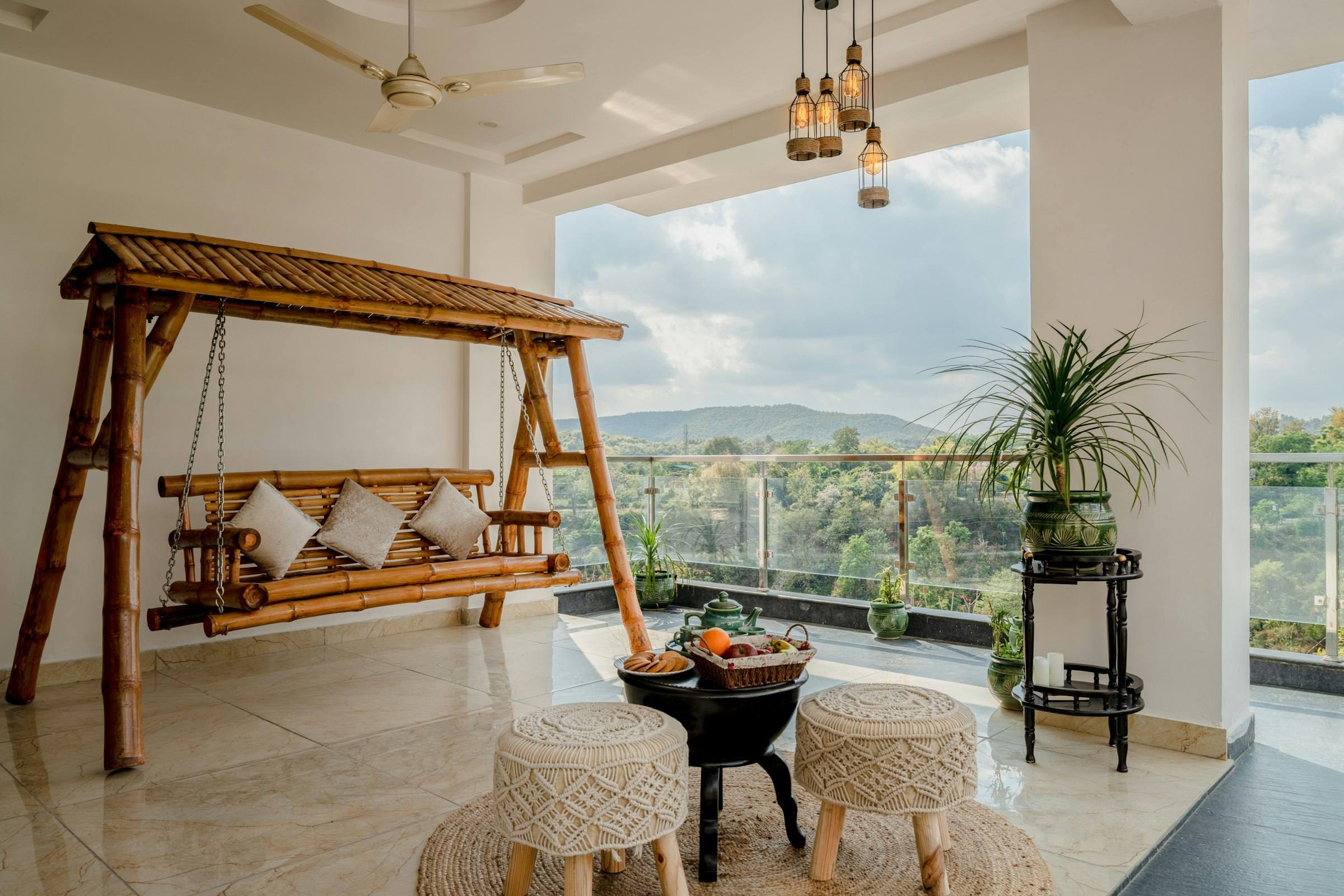 A wooden swing with cushions in a bright living room, by a wide window