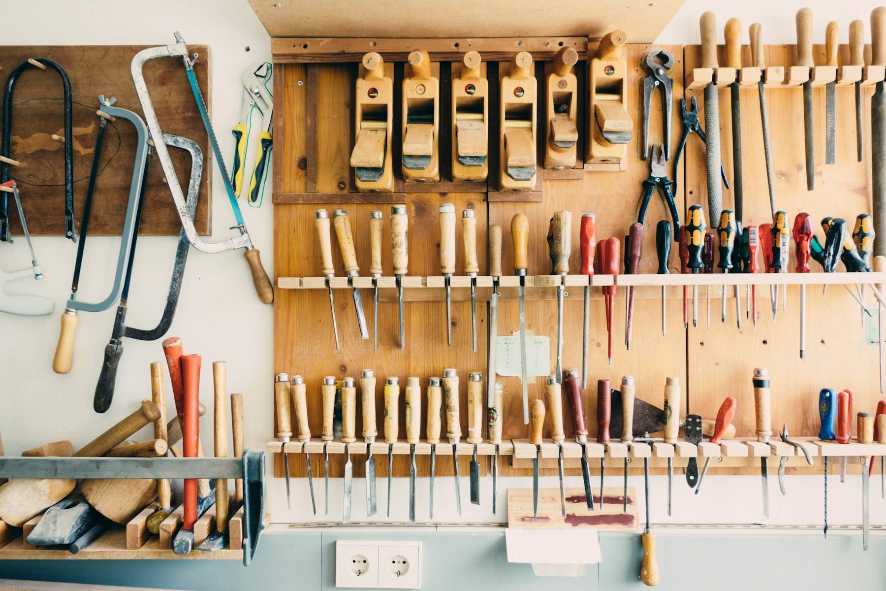 Carpentry tools hanging on a workshop wall